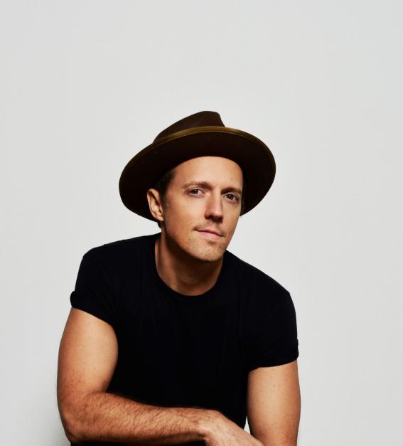 Singer-songwriter Jason Mraz -  a young-looking man in a black t-shirt wearing a black hat. 